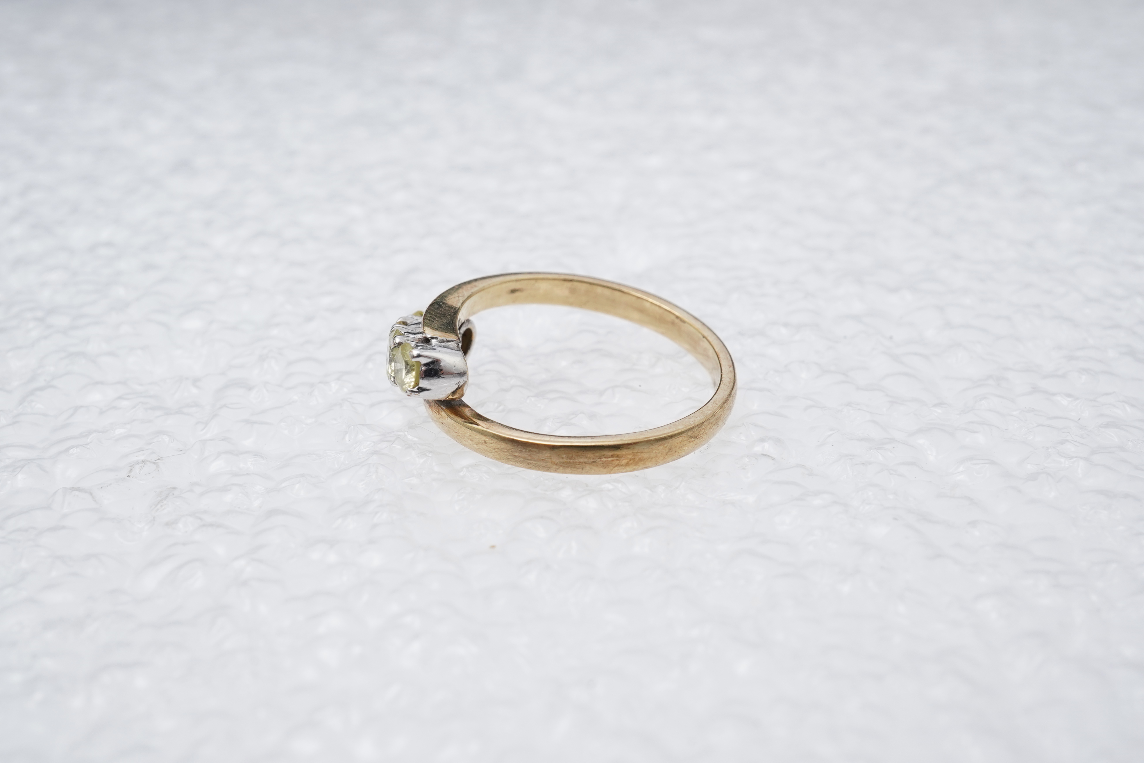 A yellow diamond ring, claw-set with four brilliant-cut diamonds of yellow tint totalling approximately 0.40 carats, mounted in gold, gross weight approximately 2 grams